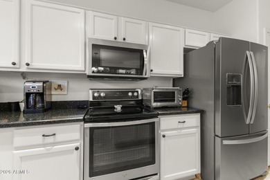 Welcoming one-owner home featuring a charming front courtyard on Sun City Grand Golf Couse and Club in Arizona - for sale on GolfHomes.com, golf home, golf lot