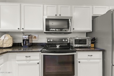 Welcoming one-owner home featuring a charming front courtyard on Sun City Grand Golf Couse and Club in Arizona - for sale on GolfHomes.com, golf home, golf lot