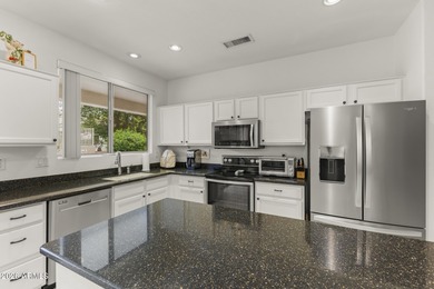 Welcoming one-owner home featuring a charming front courtyard on Sun City Grand Golf Couse and Club in Arizona - for sale on GolfHomes.com, golf home, golf lot