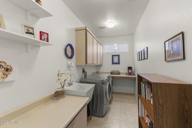 Welcoming one-owner home featuring a charming front courtyard on Sun City Grand Golf Couse and Club in Arizona - for sale on GolfHomes.com, golf home, golf lot