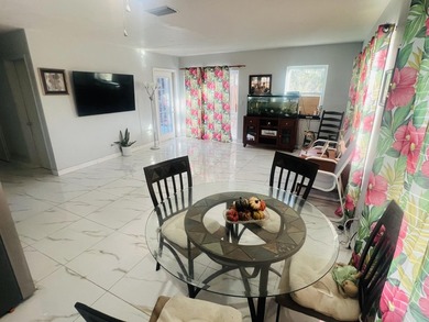 2/1 CBS NO HOA home in Port St. Lucie featuring a screened in on Club Med Sandpiper in Florida - for sale on GolfHomes.com, golf home, golf lot