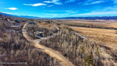 Nestled among mature trees in the heart of Star Valley Ranch on Star Valley RV Golf Course in Wyoming - for sale on GolfHomes.com, golf home, golf lot