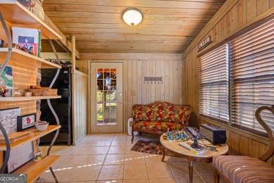 Discover this beautifully preserved mid-century lake house on Francis Lake Golf Club in Georgia - for sale on GolfHomes.com, golf home, golf lot