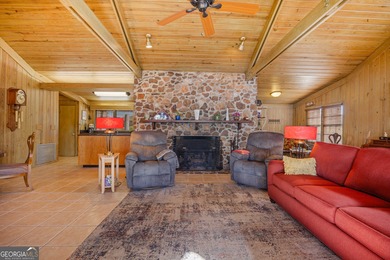 Discover this beautifully preserved mid-century lake house on Francis Lake Golf Club in Georgia - for sale on GolfHomes.com, golf home, golf lot