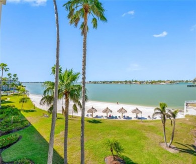 Stunning end unit offering water views galore!  This turnkey on Isla Del Sol Yacht and Country Club in Florida - for sale on GolfHomes.com, golf home, golf lot