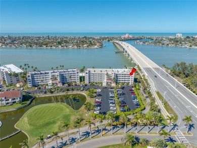 Stunning end unit offering water views galore!  This turnkey on Isla Del Sol Yacht and Country Club in Florida - for sale on GolfHomes.com, golf home, golf lot