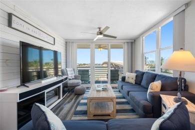 Stunning end unit offering water views galore!  This turnkey on Isla Del Sol Yacht and Country Club in Florida - for sale on GolfHomes.com, golf home, golf lot