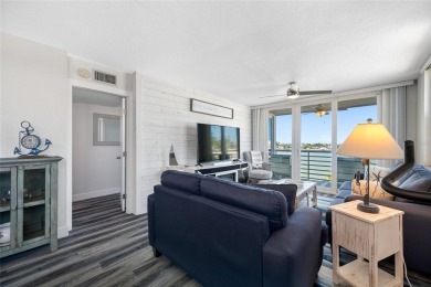 Stunning end unit offering water views galore!  This turnkey on Isla Del Sol Yacht and Country Club in Florida - for sale on GolfHomes.com, golf home, golf lot