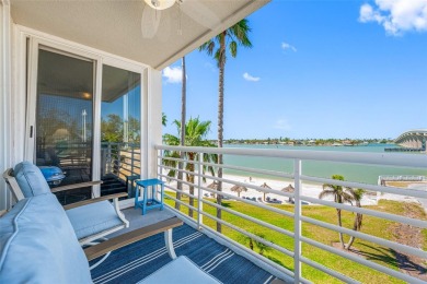 Stunning end unit offering water views galore!  This turnkey on Isla Del Sol Yacht and Country Club in Florida - for sale on GolfHomes.com, golf home, golf lot