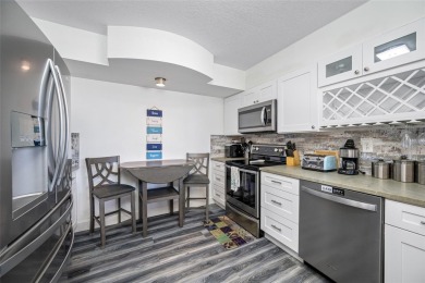 Stunning end unit offering water views galore!  This turnkey on Isla Del Sol Yacht and Country Club in Florida - for sale on GolfHomes.com, golf home, golf lot