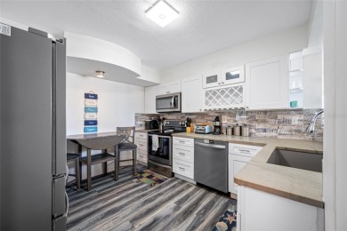 Stunning end unit offering water views galore!  This turnkey on Isla Del Sol Yacht and Country Club in Florida - for sale on GolfHomes.com, golf home, golf lot