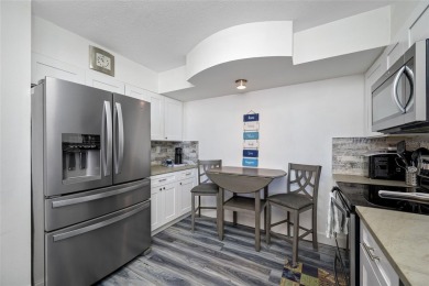Stunning end unit offering water views galore!  This turnkey on Isla Del Sol Yacht and Country Club in Florida - for sale on GolfHomes.com, golf home, golf lot