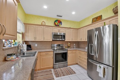 Lovely 2 bedroom, 2 bath residence with soaring vaulted ceilings on Indian Spring Golf and Country Club in Florida - for sale on GolfHomes.com, golf home, golf lot