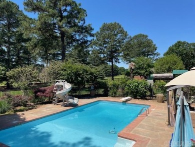 This luxury home w in-ground pool sits on a corner lot alongside on Centennial Valley Golf Course in Arkansas - for sale on GolfHomes.com, golf home, golf lot