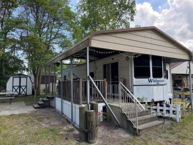 Lot with camper, camperport, deck, and shed.  Camper is in good on Captains Cove Golf and Yacht Club in Virginia - for sale on GolfHomes.com, golf home, golf lot