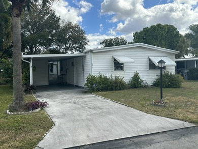 Rarely available lakefront  2BR/2BA double-wide coach home in on Boca Grove Golf and Tennis in Florida - for sale on GolfHomes.com, golf home, golf lot