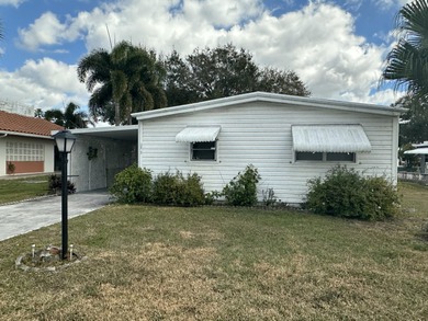 Rarely available lakefront  2BR/2BA double-wide coach home in on Boca Grove Golf and Tennis in Florida - for sale on GolfHomes.com, golf home, golf lot