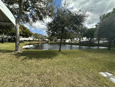 Rarely available lakefront  2BR/2BA double-wide coach home in on Boca Grove Golf and Tennis in Florida - for sale on GolfHomes.com, golf home, golf lot