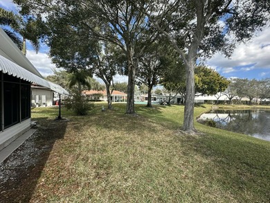 Rarely available lakefront 2BR/2BA double-wide coach home in on Boca Grove Golf and Tennis in Florida - for sale on GolfHomes.com, golf home, golf lot