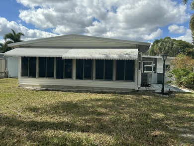Rarely available lakefront  2BR/2BA double-wide coach home in on Boca Grove Golf and Tennis in Florida - for sale on GolfHomes.com, golf home, golf lot