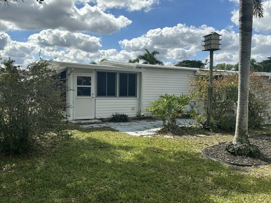 Rarely available lakefront 2BR/2BA double-wide coach home in on Boca Grove Golf and Tennis in Florida - for sale on GolfHomes.com, golf home, golf lot