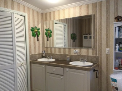 Move right into this beautifully updated home tucked back into a on Spanish Lakes I in Florida - for sale on GolfHomes.com, golf home, golf lot