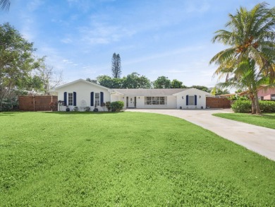 THIS SPACIOUS 4 BEDROOM/2 BATH HOME WITH A LARGE SCREENED IN on Tequesta Country Club in Florida - for sale on GolfHomes.com, golf home, golf lot