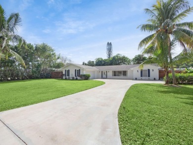 THIS SPACIOUS 4 BEDROOM/2 BATH HOME WITH A LARGE SCREENED IN on Tequesta Country Club in Florida - for sale on GolfHomes.com, golf home, golf lot