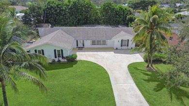 THIS SPACIOUS 4 BEDROOM/2 BATH HOME WITH A LARGE SCREENED IN on Tequesta Country Club in Florida - for sale on GolfHomes.com, golf home, golf lot