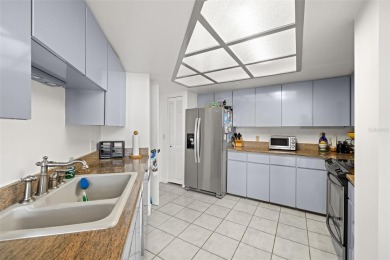 Lush tropical and water views await from this 12th floor condo on Pasadena Yacht and Country Club in Florida - for sale on GolfHomes.com, golf home, golf lot