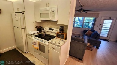 This charming 1 bedroom, 1.5 bathroom residence in Century on Hillsboro Pines Golf in Florida - for sale on GolfHomes.com, golf home, golf lot