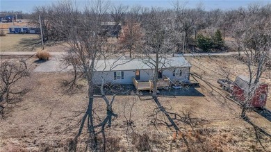 This home is the perfect blend of comfort, charm, function, and on Linn Valley Lakes - Deer Trace Golf Course in Kansas - for sale on GolfHomes.com, golf home, golf lot