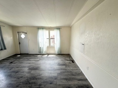 PRICED TO SELL!!! This 2-bedroom, 2 full bath home needs someone on Grasslands Golf and Country Club in Florida - for sale on GolfHomes.com, golf home, golf lot