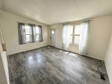 PRICED TO SELL!!! This 2-bedroom, 2 full bath home needs someone on Grasslands Golf and Country Club in Florida - for sale on GolfHomes.com, golf home, golf lot