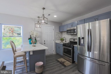 This charming end-of-row townhouse, built in 1924, seamlessly on Clifton Park Golf Course in Maryland - for sale on GolfHomes.com, golf home, golf lot
