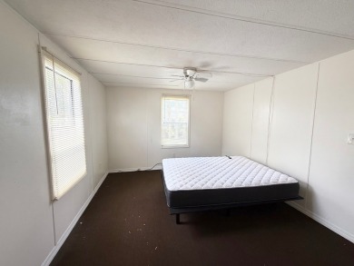 PRICED TO SELL!!! This 2-bedroom, 2 full bath home needs someone on Grasslands Golf and Country Club in Florida - for sale on GolfHomes.com, golf home, golf lot