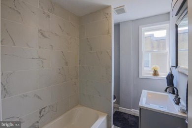 This charming end-of-row townhouse, built in 1924, seamlessly on Clifton Park Golf Course in Maryland - for sale on GolfHomes.com, golf home, golf lot