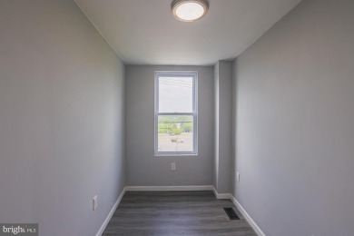 This charming end-of-row townhouse, built in 1924, seamlessly on Clifton Park Golf Course in Maryland - for sale on GolfHomes.com, golf home, golf lot