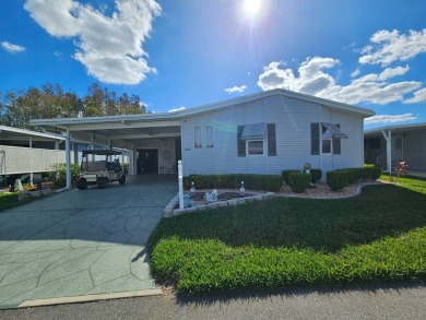 This 1995 Palm Harbor has lovely pond views and (no water on Big Cypress Golf and Country Club in Florida - for sale on GolfHomes.com, golf home, golf lot