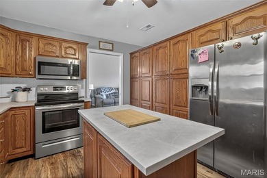 Water view sprawling ranch  home in beautiful Raintreee on Raintree Country Club in Missouri - for sale on GolfHomes.com, golf home, golf lot