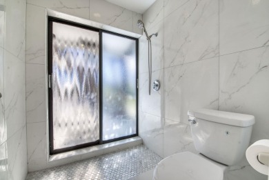 This extremely bright and expansive lakefront home in Greenview on Greenview Cove Golf Club in Florida - for sale on GolfHomes.com, golf home, golf lot