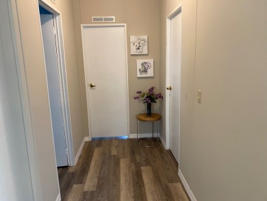 Cozy Open Concept mobile home in vibrant 55+ community on leased on Spanish Lakes Fairways in Florida - for sale on GolfHomes.com, golf home, golf lot