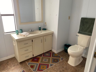 Cozy Open Concept mobile home in vibrant 55+ community on leased on Spanish Lakes Fairways in Florida - for sale on GolfHomes.com, golf home, golf lot