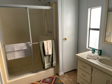 Cozy Open Concept mobile home in vibrant 55+ community on leased on Spanish Lakes Fairways in Florida - for sale on GolfHomes.com, golf home, golf lot