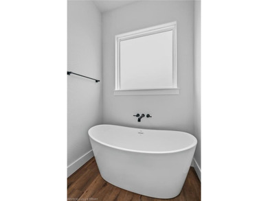 Welcome to East Village! This thoughtfully designed 3-bedroom, 2 on Vache-Grasse Country Club in Arkansas - for sale on GolfHomes.com, golf home, golf lot