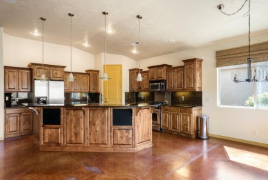 Well-kept home right on the golf course with red mountain views! on Green Spring Country Club in Utah - for sale on GolfHomes.com, golf home, golf lot