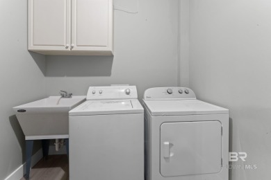 Start your morning with a coffee on the porch swing while you on Kiva Dunes Golf Club in Alabama - for sale on GolfHomes.com, golf home, golf lot