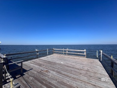 Start your morning with a coffee on the porch swing while you on Kiva Dunes Golf Club in Alabama - for sale on GolfHomes.com, golf home, golf lot