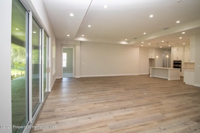 This beautiful semi-custom home by Spire Homes is set on a on Southern Hills Plantation Club in Florida - for sale on GolfHomes.com, golf home, golf lot