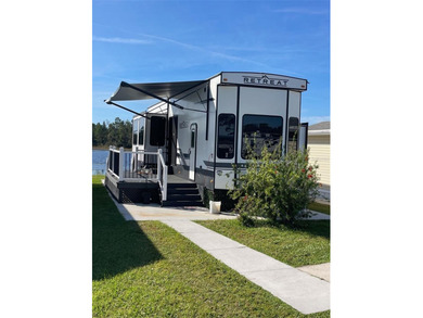 LAKEFRONT LIVING! RETIRE WITH CONFIDENCE!! Welcome to Kove on Cypress Point RV Golf Club in Florida - for sale on GolfHomes.com, golf home, golf lot